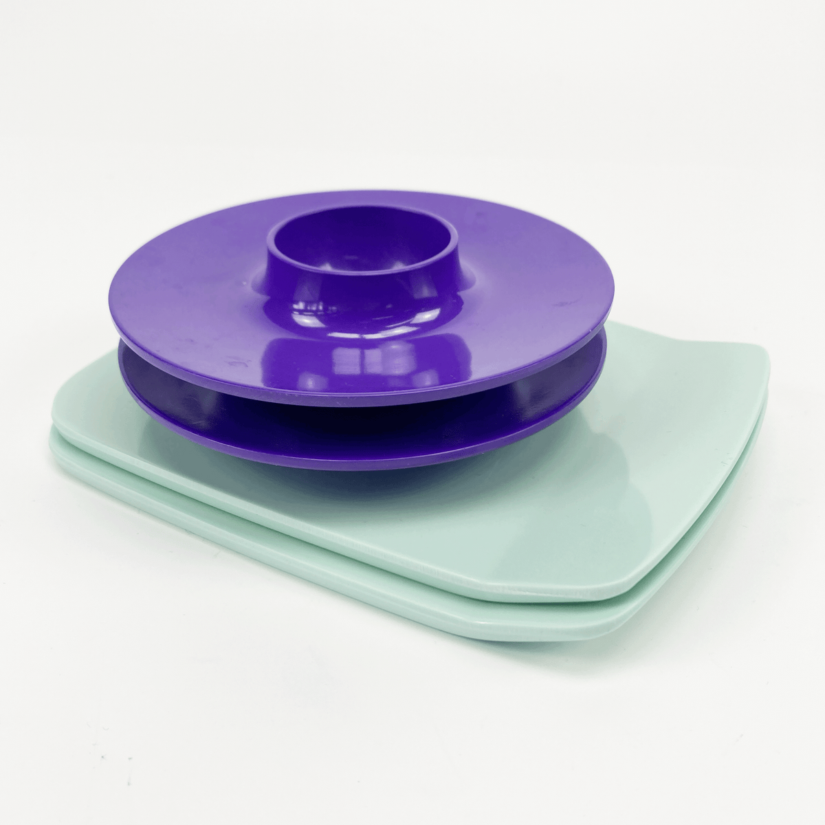Purple lid and light blue trays on a white background