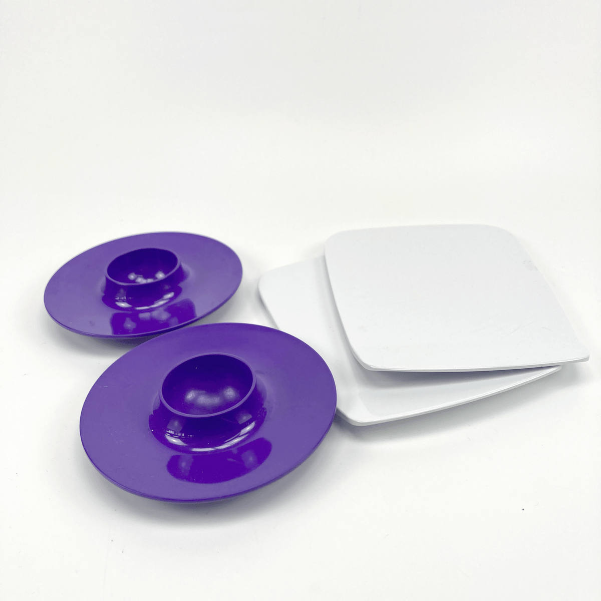 Two purple circular objects with a white rectangular object on a light gray background