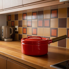 Load image into Gallery viewer, Red container with wooden handle on a blue background