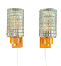 Load image into Gallery viewer, Two wall-mounted lamps with textured glass shades and wooden bases on a white background
