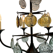 Load image into Gallery viewer, Svend Aage Holm Sørensen Viking 6-Arm Cast Iron Chandelier, Amber Glass, 1960s. Decorative chandelier with hanging coins and candles on a white background