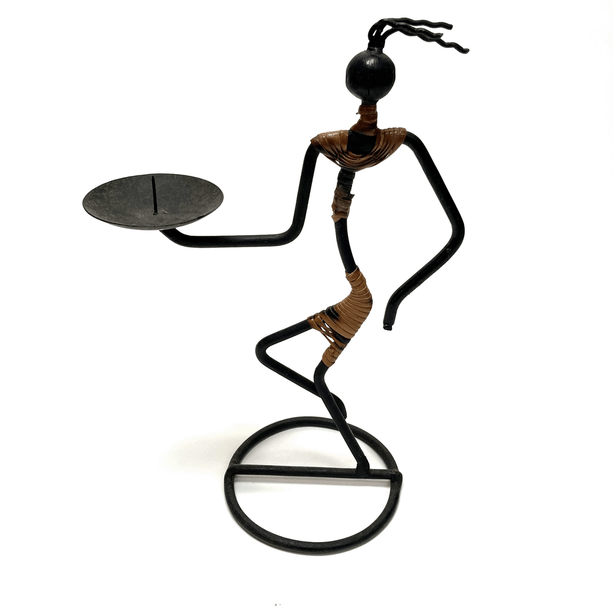 Decorative metal sculpture of a figure with a candle holder on a white background