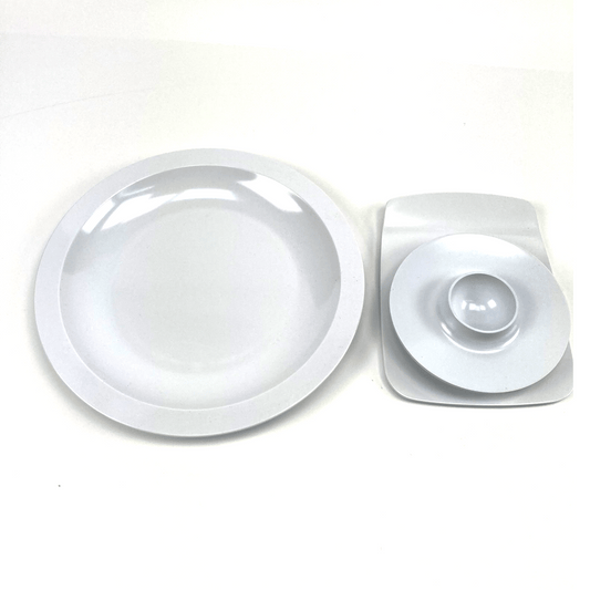 Round white melamine egg cup, buttering board, and a plate with a central indentation on a white background