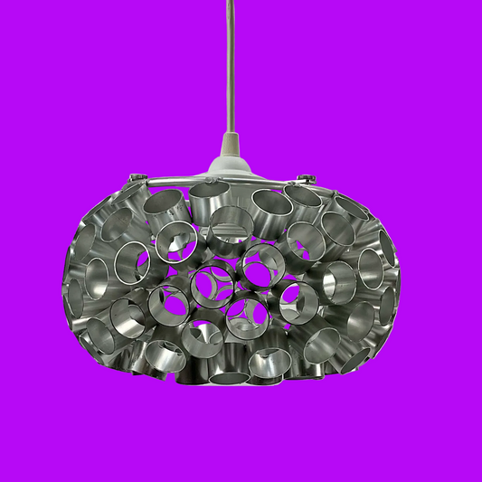 On a purple background, a metallic pendant light featuring a cylindrical design