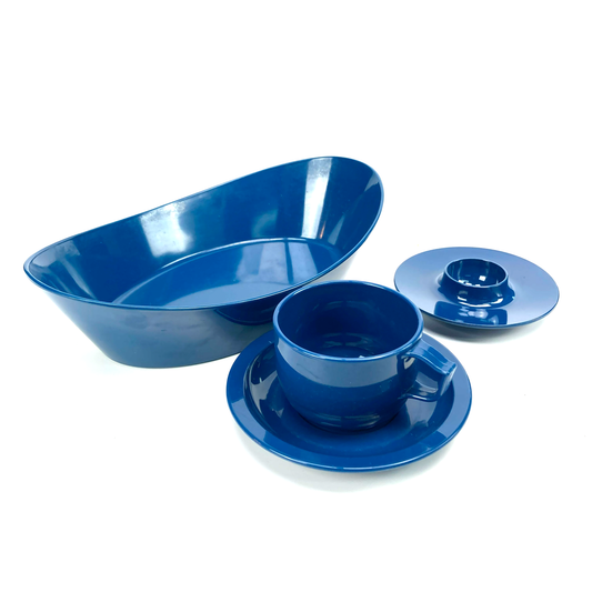 Set of blue melamine dishes, including a bowl, cup, and saucer, on a white background
