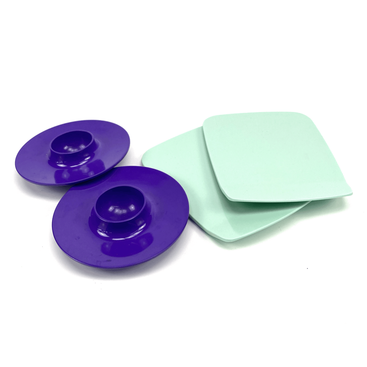 Two purple circular objects and two light green square objects on a white background