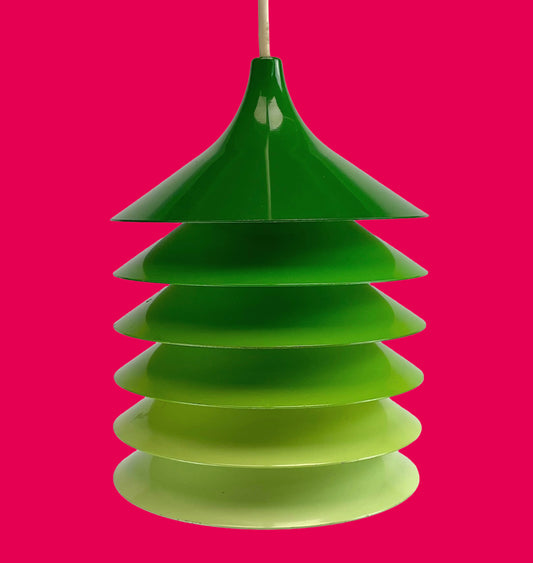 Green layered pendant light on a pink background