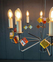 Load image into Gallery viewer, Decorative chandelier with multiple light bulbs and colorful glass blocks against a dark background
