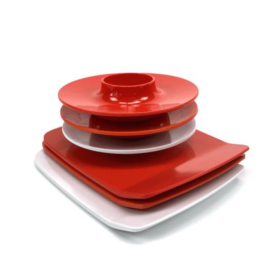 Stack of red and white melamine plates on a white background