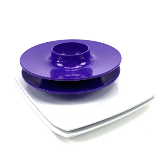 Purple plastic component on a white background