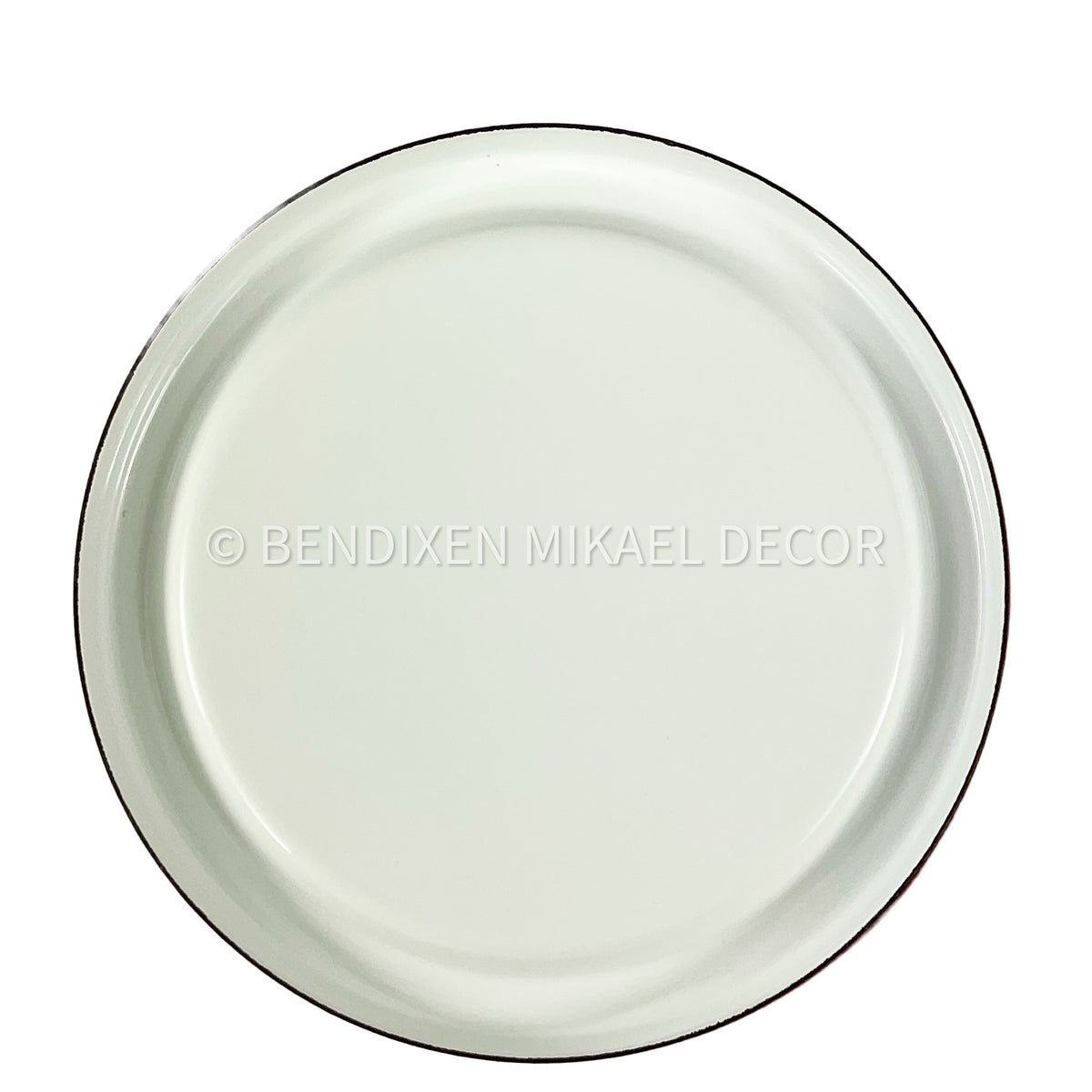 White ceramic plate with black rim on a white background