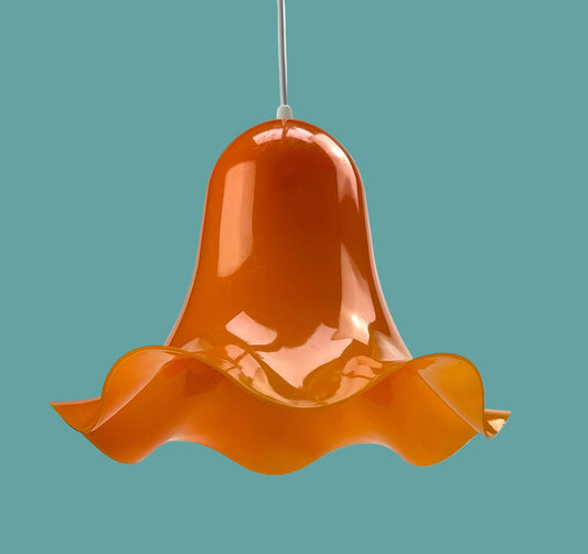 Flower-shaped lamp pendant from the 70s, orange plastic, rim with a wave look.