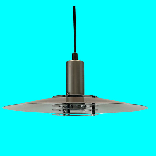 Modern pendant light with metallic finish on a turquoise background