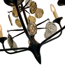 Load image into Gallery viewer, Svend Aage Holm Sørensen Viking 6-Arm Cast Iron Chandelier, Amber Glass, 1960s. Decorative chandelier with candle-style lights and metallic coin-like ornaments on a white background.

