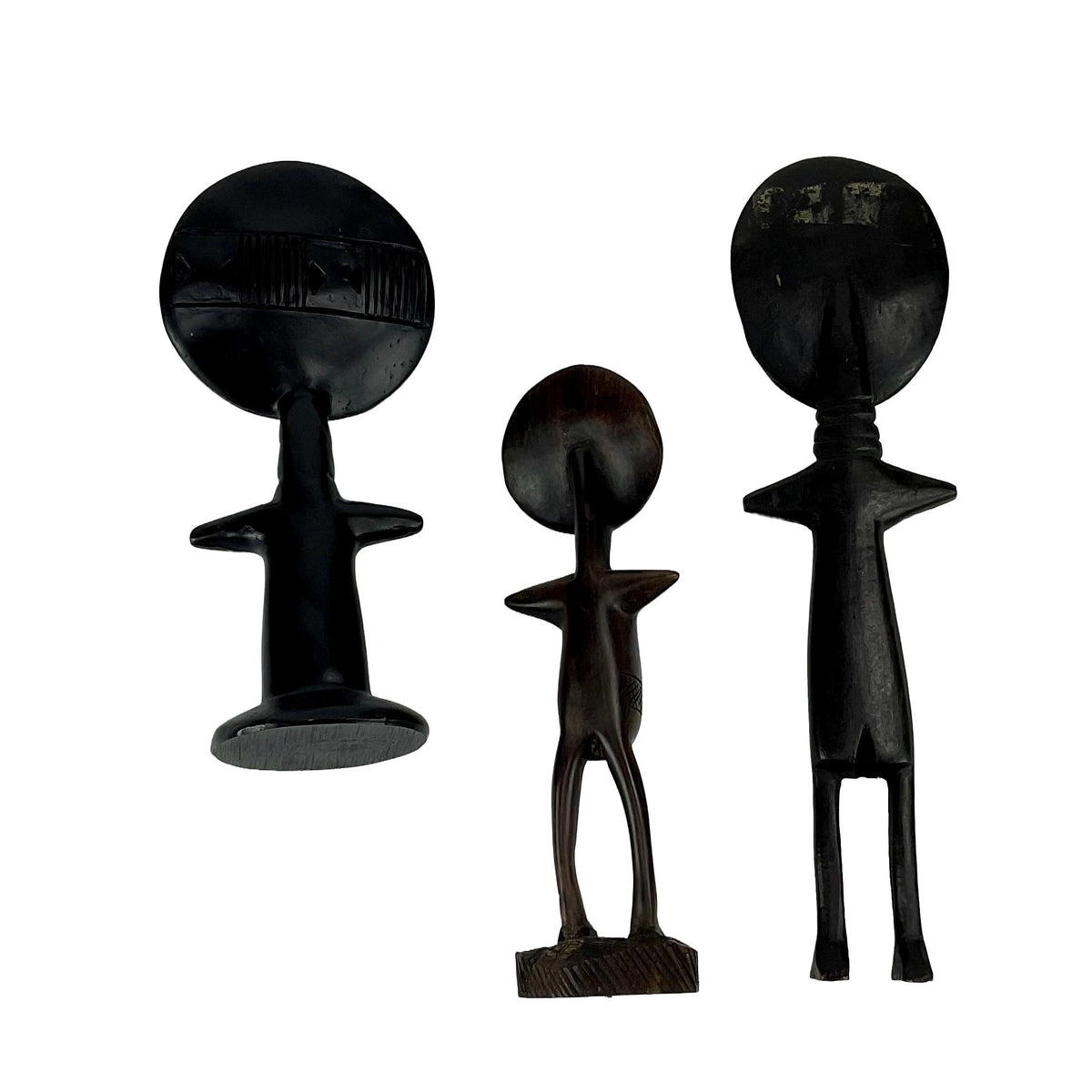 Three black figures of different designs on a white background