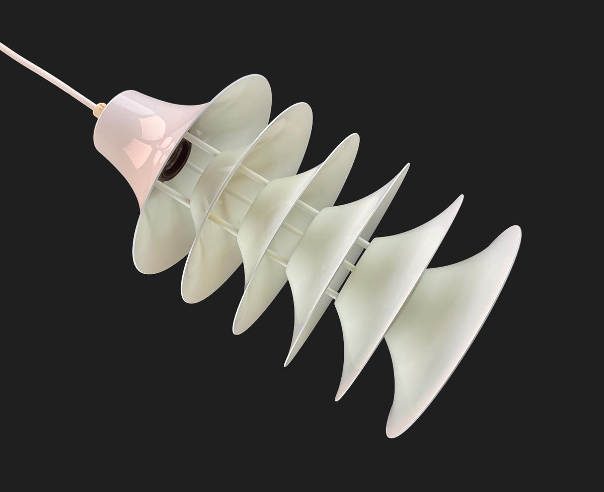 Modern pendant light with white glass shades on a black background