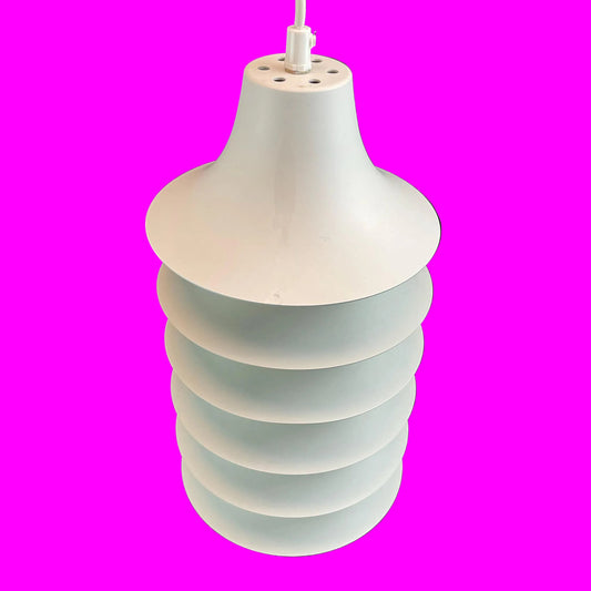 Pendant light with layered design on a pink background
