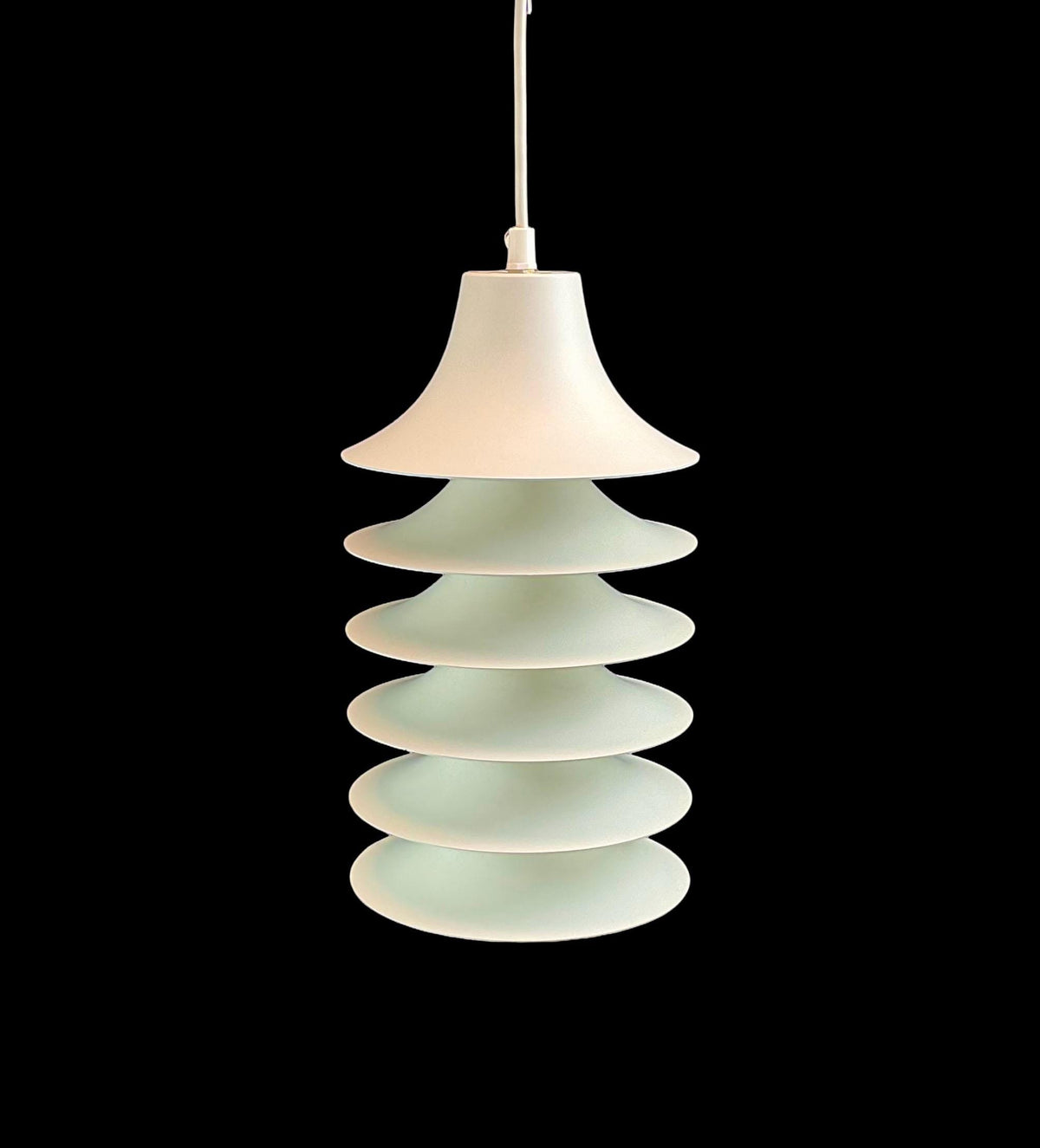 Pendant light with stacked circular design on a black background