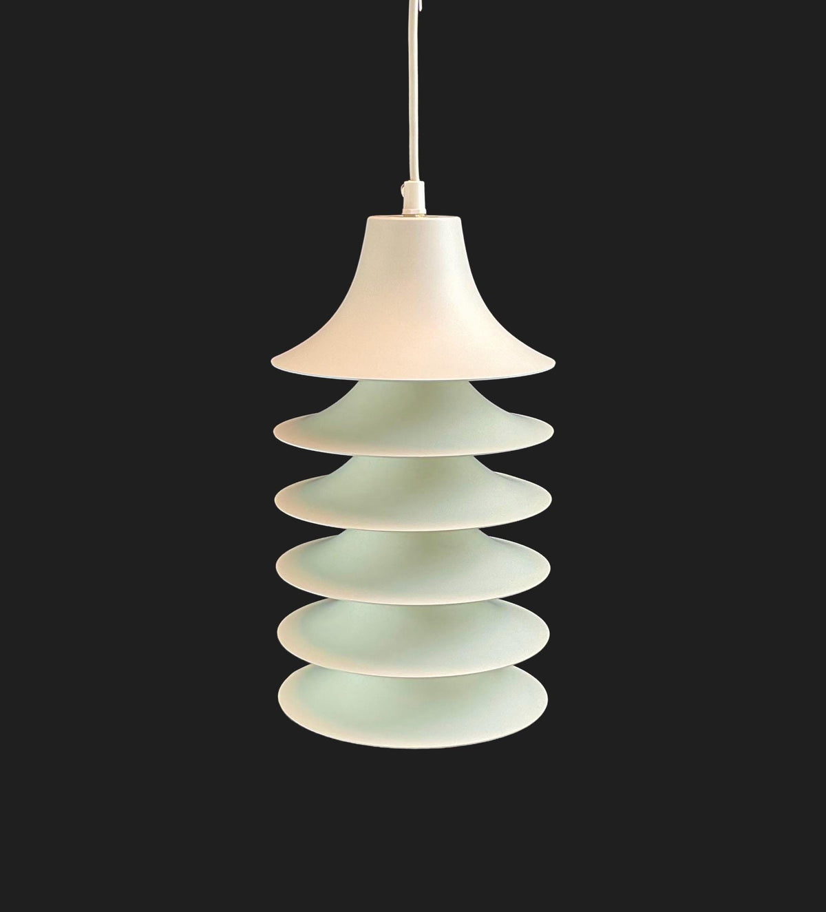 Pendant light with stacked circular design on a black background
