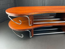 Load image into Gallery viewer, Wooden rack with metal hooks on a gray floor against a dark brick wall.
