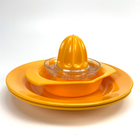 Yellow citrus juicer with a bowl on a white background