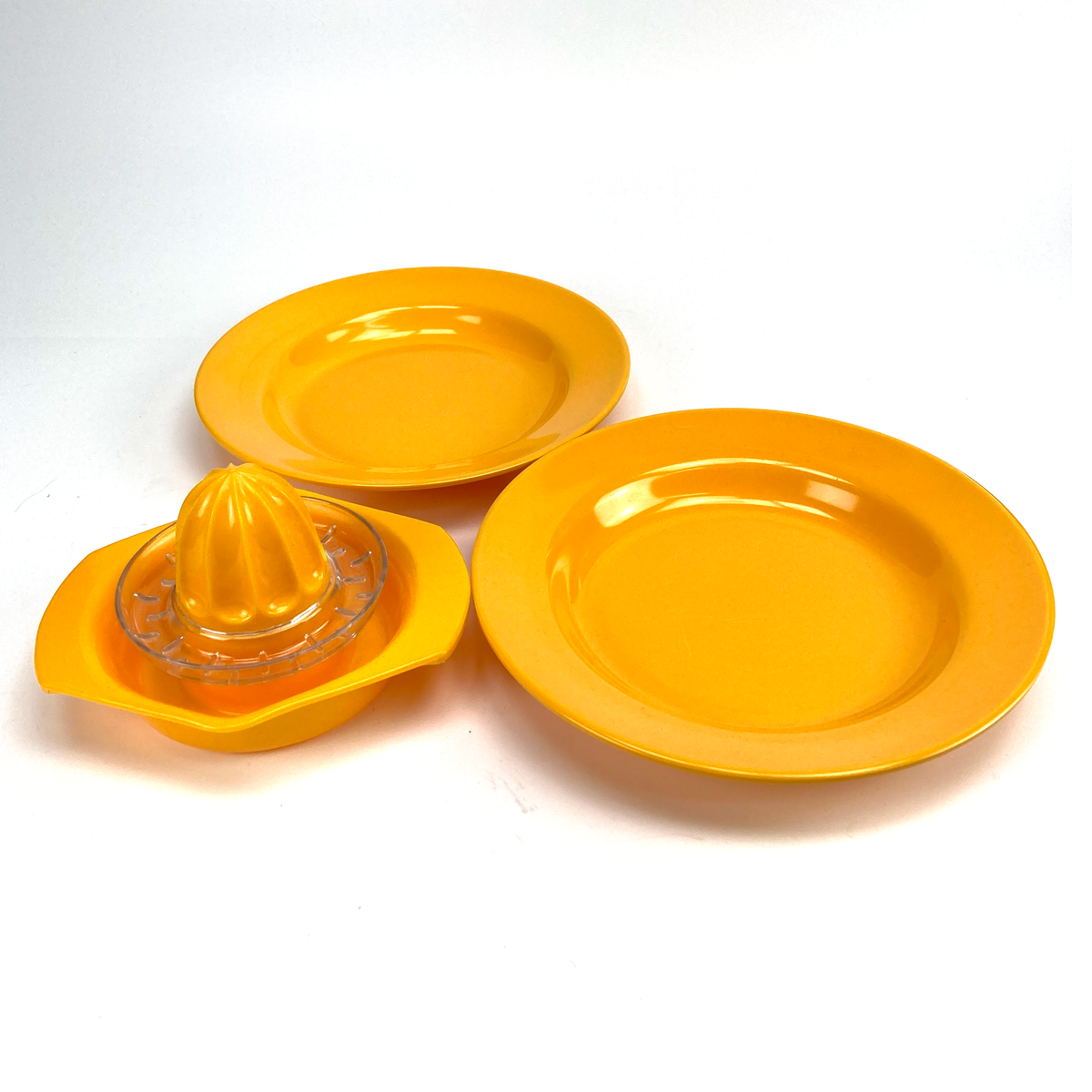 Yellow kitchen tool with two plates on a white background