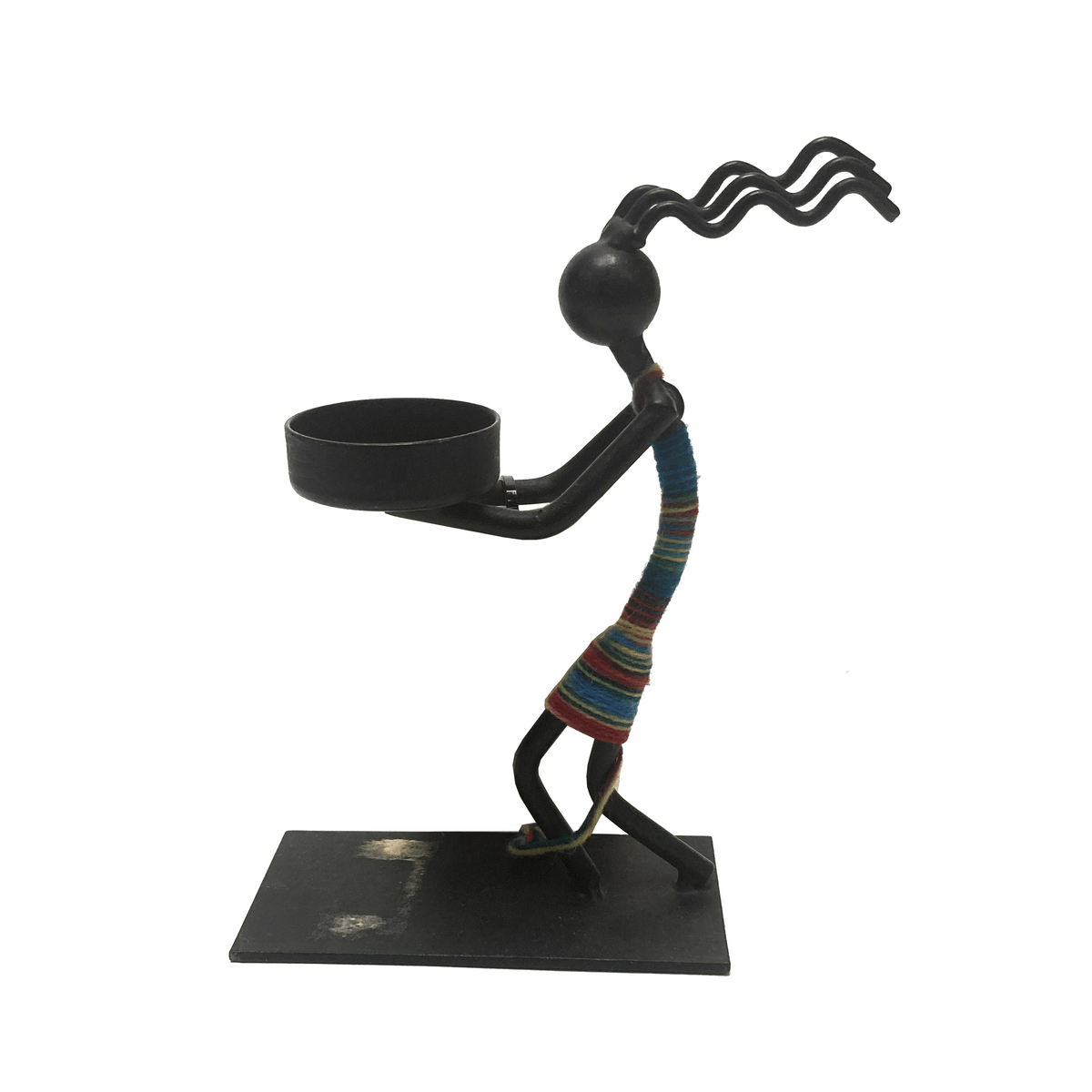 Metallic sculpture of a figure with a colorful striped garment holding a bowl on a white background