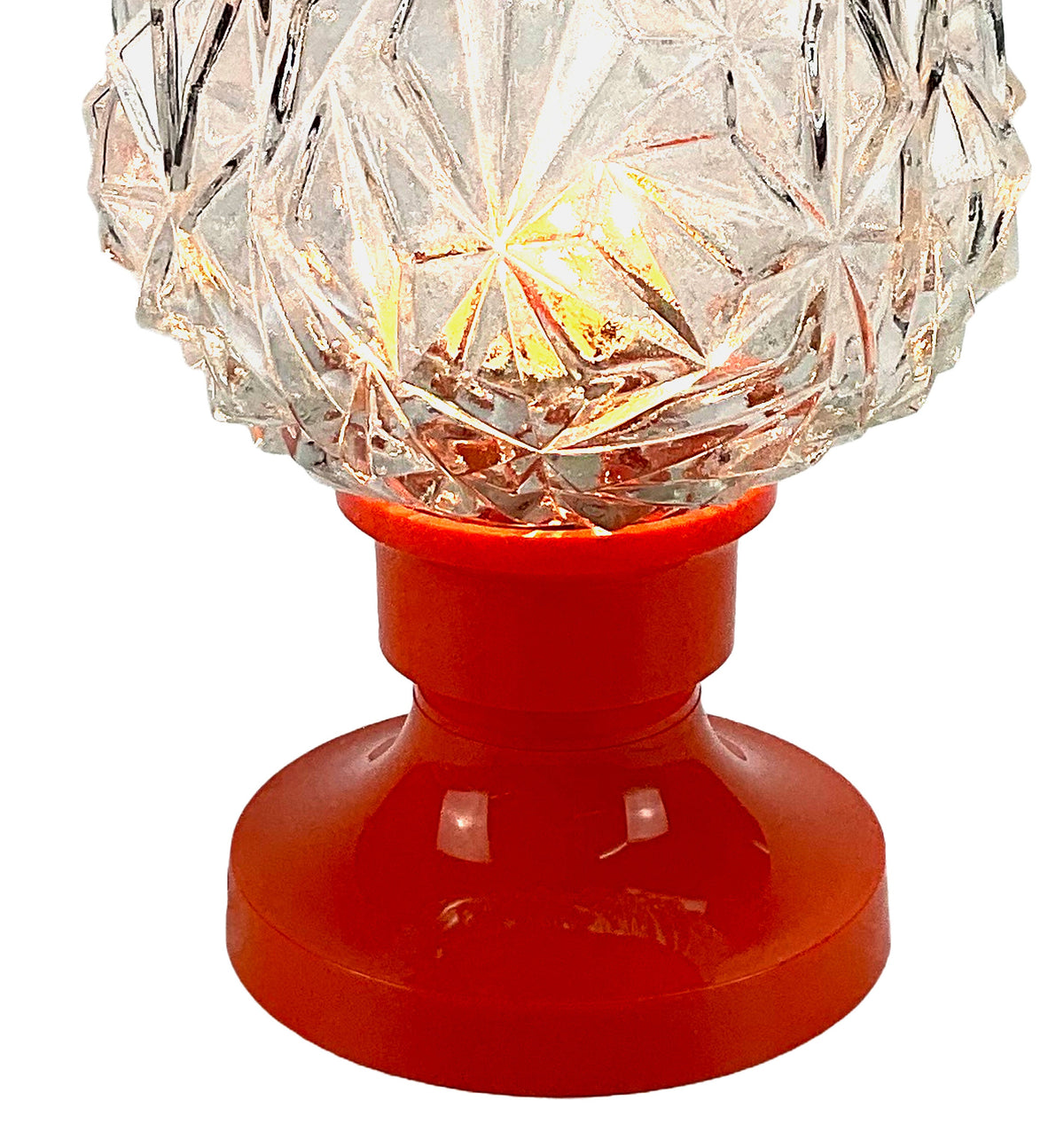 Decorative lamp with crystal shade and red base on a white background